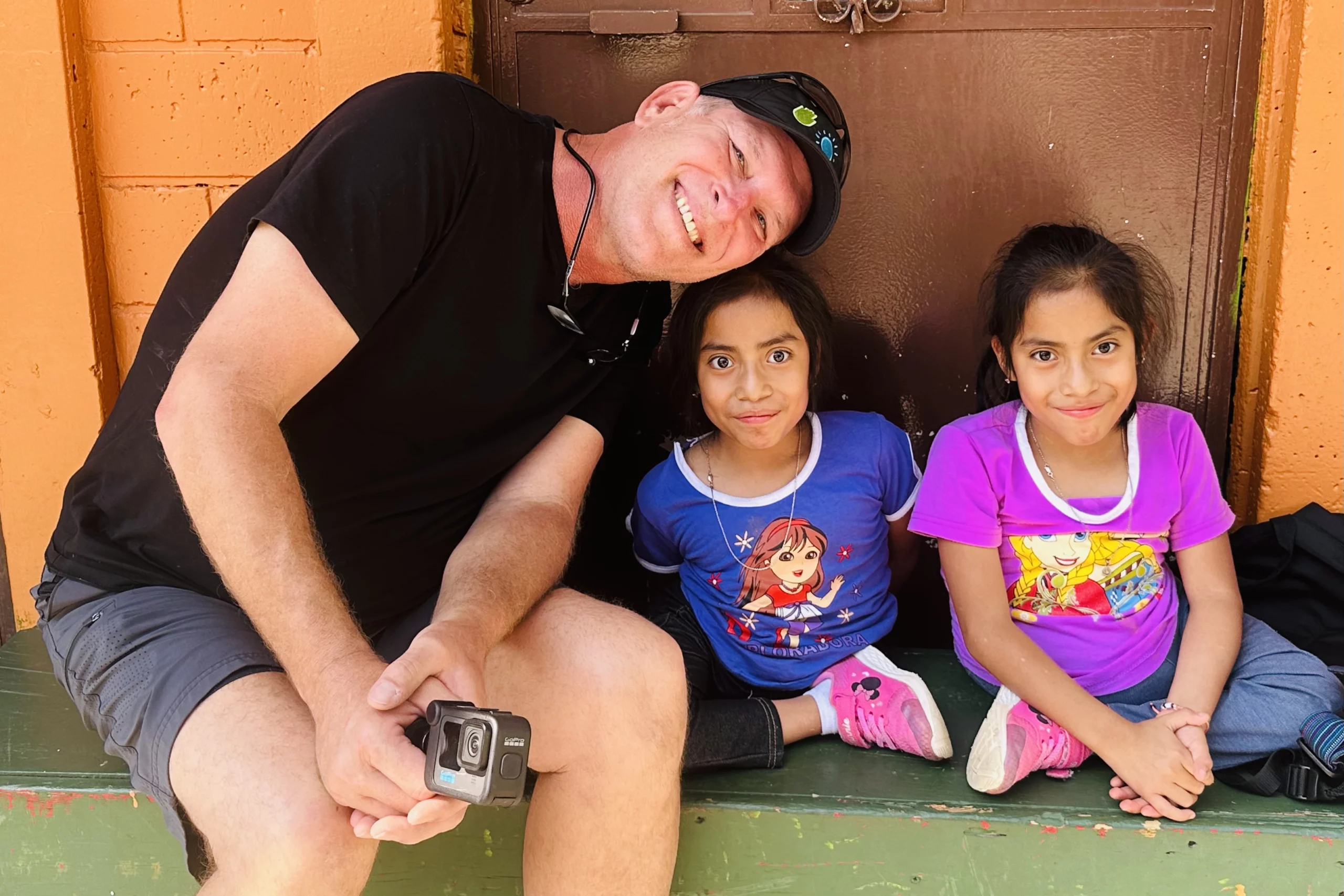 Man filmmaker with two orphan girls in Guatemala.